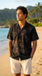 Man on the beach at sunset in the Simple Bamboo rayon aloha shirt in black